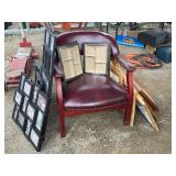 Red vinyl upholstered chair with short legs and assortment of photo frames