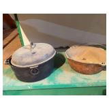 Two cast iron Dutch ovens Blacker one is marked Favorite Piqua Ware, 6