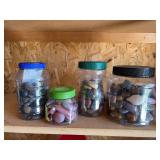 Four containers full of polished rocks and stones