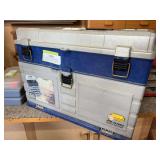 Blue and gray tacklebox, full of fishing supplies and tackle