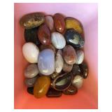 Tote full of highly polished stones and petrified wood