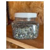 Large quantity plastic container of Montana sapphires