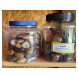 Two plastic containers full of polished stones - lots of color variety