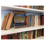 Shelf full of reading novels, vintage, and antique