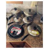 Set of five Revere ware, cooking pans with lids and new drip pans for stove