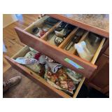 Contents of lower kitchen cupboards includes flatware, some plasticware, utensils, cookware, pans