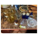Juice reamers, blue glass salt and pepper shakers, pitchers, and ice cream scoops.