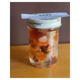 Small jar, full of orange stones, suspended and oil
