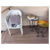 Two plant stands and three plastic chairs