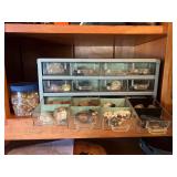 Plastic container full of shiny rocks and large specimen sample of rock and gems
