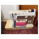 Singer sewing machine, dress patterns, lots of thread and sewing notions