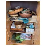 Double door, pantry style storage cupboard, and some baskets and craft items