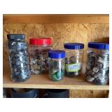 Five jars full of polished rocks and stones, including petrified wood, agate, etc.