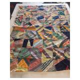 Vintage crazy quilt featuring a variety of fabrics 63x80