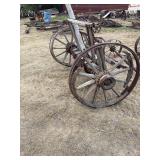 Two wood wagon wheels with some running gear -bring help to load