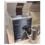 2 coffee makers and a small pot