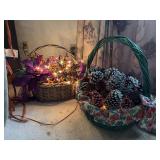 Two lighted baskets w pine cones