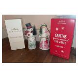 Two Hallmark table decorations-Santa’s from Around the World and Snowtop Lodge