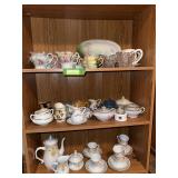 Bottom three shelves of pottery includes hand painted cream & sugars, tea sets, mini pitchers and basins, etc