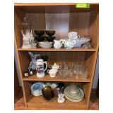 Three shelves includes Pinky & Blue boy plates, covered comport, ashtrays, green glass and more