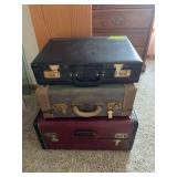 Two vintage suitcases and a briefcase