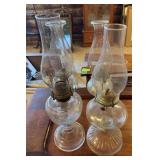 Four clear glass oil lamps