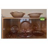 Top two shelves of pink depression glass
