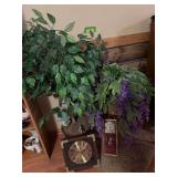 Artificial plants and two wall clocks
