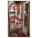 Three shelves of ruby flash and ruby glass