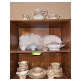 Three shelves of hand painted china as shown