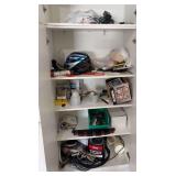 In cabinet includes bicycle helmet, light bulbs, fishing reel, antifreeze, rod holder and more