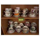 Two shelves of cups & saucers