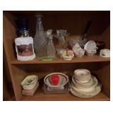 Bottom two shelves includes decanters, cups, an apple, enamel ladle, vases, china dishes and more