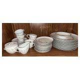 Bottom shelf of uncounted, unsorted Style House Tudor Rose china