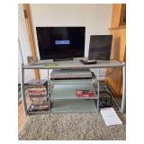 Entertainment stand w Vizio 23” tv, RCA antenna, DVD’s, Insignia wireless headphones, Sony DVD/VHS player