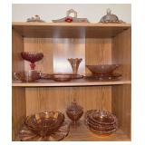 Three shelves of pink depression glass
