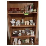Four shelves of glassware includes cups & saucers, ruby flash glass, figurines and more