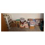 In closet includes wall art, trash cans, books, storage drawers