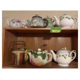 Two shelves of teapots