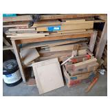 Qty of misc lumber on left side of shop, boards, dowels, ballisters etc ..