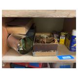 Shelf full of leather working items, including some leather tools, leather dye and polish, shoe shine items