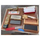 Assorted sharpening stones, brass hammers, lead hardness tester