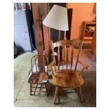 Child’s wooden chair, oak armchair, floor lamp, and throw blanket
