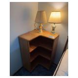 Unique retro corner bookshelf with two brass lamps