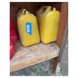 Two diesel cans one full in shed by camper