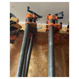 Eight large pipe clamps