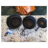 Three cast-iron skillets largest is Wagner