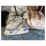 Blue themed JC Penney’s king-size quilt and additional bedding