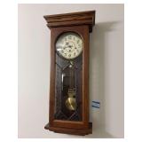 “Gold Medallion Clock”  Ansonia wall hanging clock with Oak frame