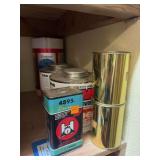 Three large canisters, partially full of gunpowder and three smaller canisters